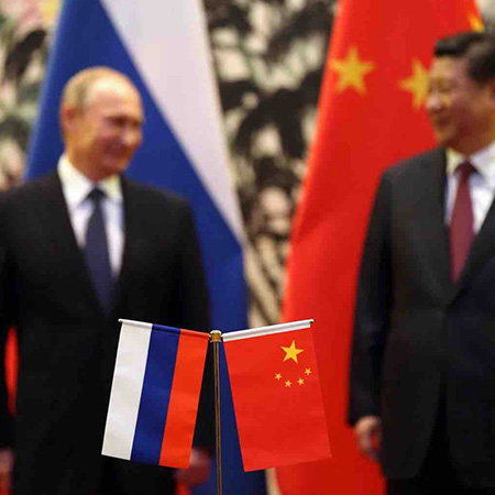 The Russian and Chinese national flags are seen on the table as Russia's President Vladimir Putin and his China's President Xi Jinping stand during a signing ceremony at the Diaoyutai State Guesthouse in Beijing on Nov. 9, 2014. Accessed from Foreign Poli