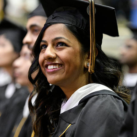 Johns Hopkins SAIS student in cap and gown during commencement