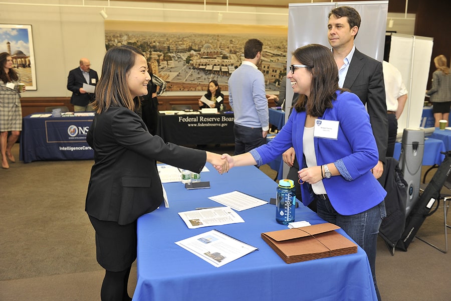 Johns Hopkins SAIS student shaking hands at a career fair