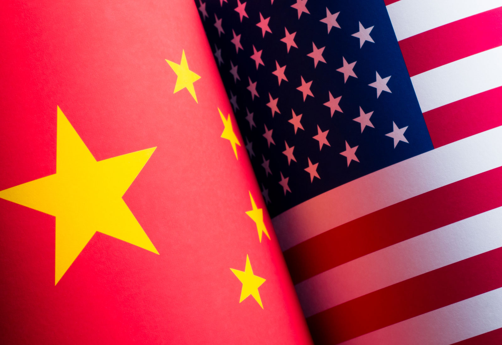 An American and Chines flag pressed against each other