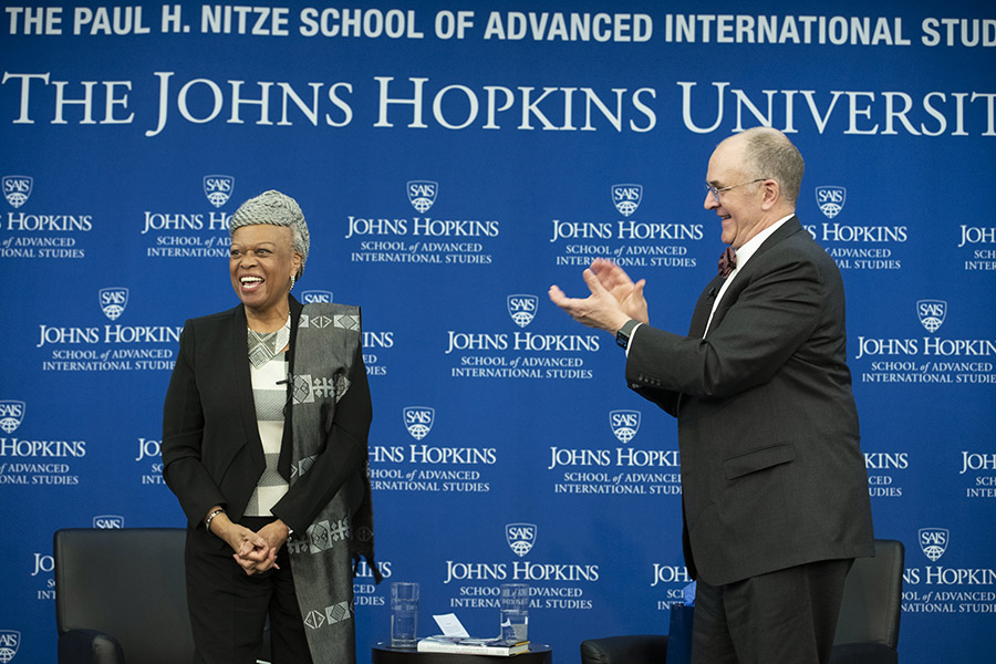 Dean Eliot A. Cohen applauds Ambassador Harriet L. Elam-Thomas after a conversation that took place at the school. 
