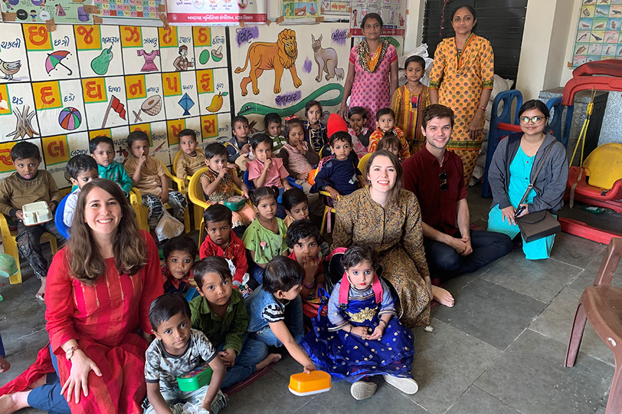 Students visit a school in India to conduct research on the country's take-home rations program.