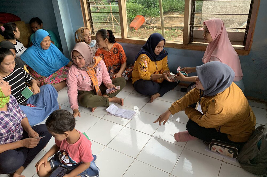 Students visit a village in Indonesia to conduct research on microfinance.
