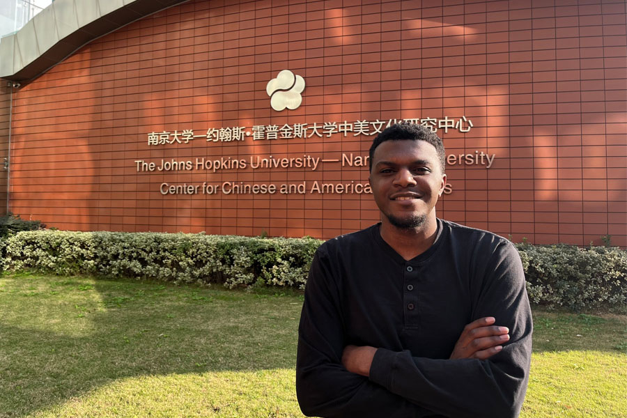 Photo of student in front of an HNC building 