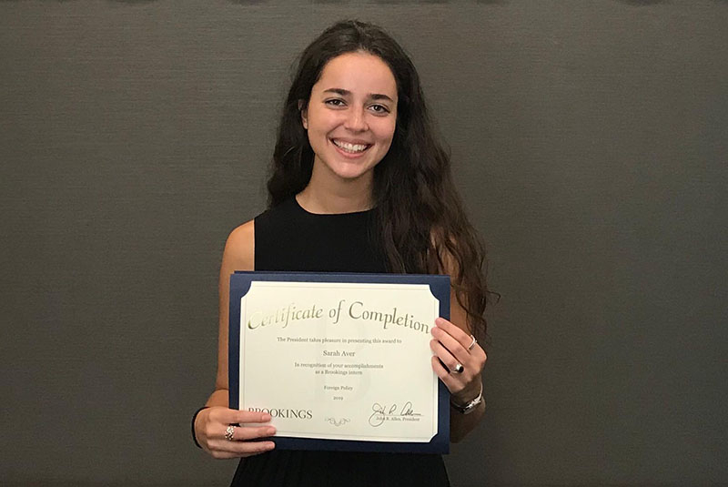 photo of SAIS student holding an award certificate 