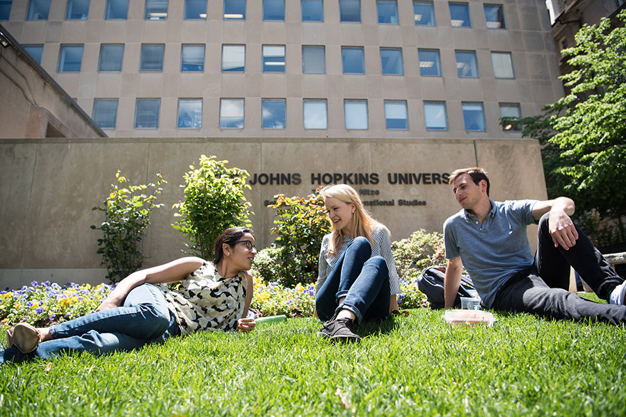 students sitting on lawn